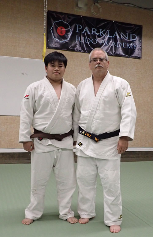 Jon Crisostomo stands next to Mickey Fitzgerald at the Parkland Judo Academy